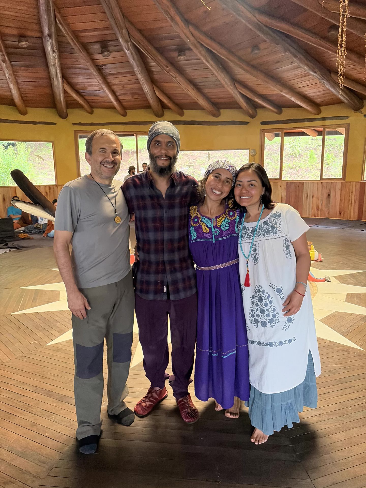 The hosts with friends gathered in the round wooden ceremony hall