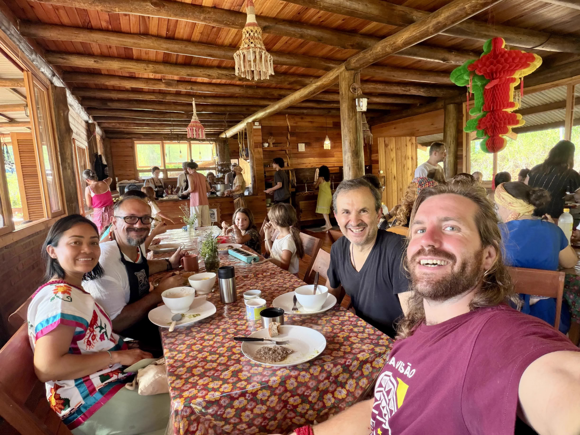 Guests sharing a meal in the wooden dining hall